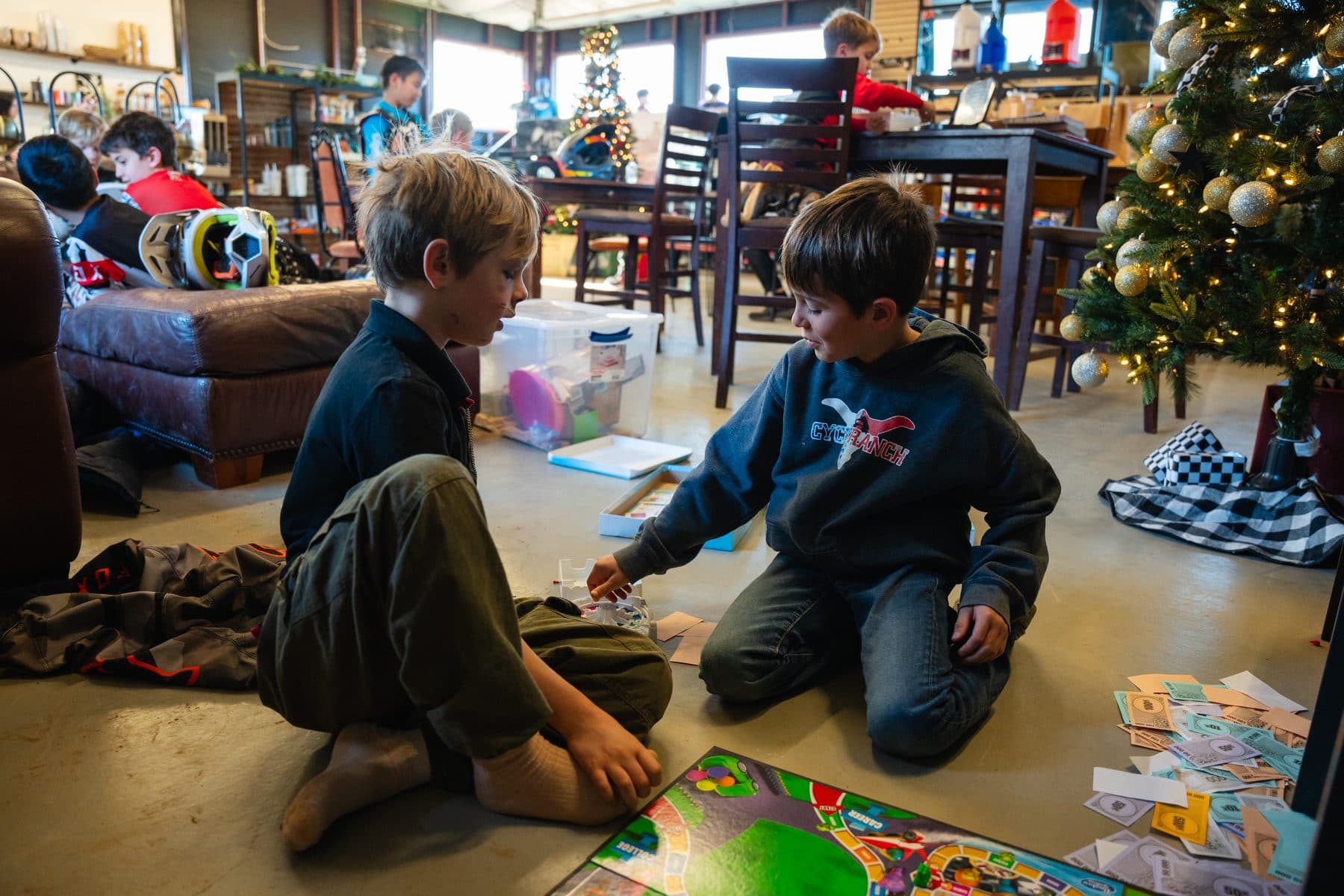Kids relaxing and playing indoors at the Cycle Ranch clubhouse between rides